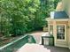 Green-railed deck with stairs leading to a backyard area with trees at 2401 Worthing Ct, Wake Forest, NC 27587