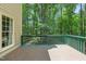 View of the outdoor deck showing green rails with wooded scenery at 2401 Worthing Ct, Wake Forest, NC 27587