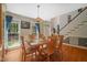 Dining area featuring hardwood floors and large windows with views of the landscaped exterior at 2401 Worthing Ct, Wake Forest, NC 27587