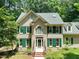 Charming two-story brick home with green shutters and a well manicured lawn at 2401 Worthing Ct, Wake Forest, NC 27587