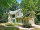 Side exterior view of a two-story brick house with green shutters and a landscaped yard at 2401 Worthing Ct, Wake Forest, NC 27587