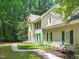 Exterior side view showing the brickwork and trim with a bench to enjoy the yard at 2401 Worthing Ct, Wake Forest, NC 27587