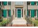 Close-up of the front entrance, featuring a green door, brick steps, and black railing at 2401 Worthing Ct, Wake Forest, NC 27587