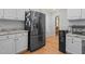 Kitchen featuring stainless steel refrigerator, granite countertops, and hardwood floors at 2401 Worthing Ct, Wake Forest, NC 27587