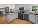 Well-lit kitchen featuring granite countertops, stainless steel appliances, and hardwood floors at 2401 Worthing Ct, Wake Forest, NC 27587