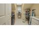 Functional laundry area with washer, shelving, and storage space at 2401 Worthing Ct, Wake Forest, NC 27587