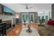 Open living room features hardwood floors, fireplace, large windows, and ceiling fan at 2401 Worthing Ct, Wake Forest, NC 27587