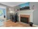 Living room with fireplace, hardwood floors, and a large TV above the mantel at 2401 Worthing Ct, Wake Forest, NC 27587