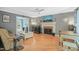Living room features hardwood floors, fireplace and ceiling fan at 2401 Worthing Ct, Wake Forest, NC 27587