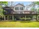 Spacious backyard with a multi-level deck, lush greenery, and ample outdoor living space at 2612 Scarlet Sage Ct, Raleigh, NC 27613