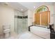 Bathroom featuring a soaking tub, tile flooring, glass enclosed shower, and modern finishes at 2612 Scarlet Sage Ct, Raleigh, NC 27613