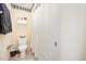 Clean bathroom with white fixtures including toilet, white shower curtain, and practical storage shelves at 2612 Scarlet Sage Ct, Raleigh, NC 27613