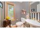 Powder room featuring modern finishes, a pedestal sink, and window overlooking the outdoors at 2612 Scarlet Sage Ct, Raleigh, NC 27613
