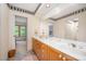Well-lit bathroom with double sink vanity, tiled floors, and a decorative border, creating a calming spa-like atmosphere at 2612 Scarlet Sage Ct, Raleigh, NC 27613