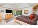 Well lit bedroom featuring modern furniture, ceiling fan, and view to surrounding woods at 2612 Scarlet Sage Ct, Raleigh, NC 27613