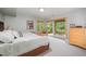 Bedroom with a cozy bed, dresser, and glass sliding doors offering access to a patio and views of the backyard at 2612 Scarlet Sage Ct, Raleigh, NC 27613