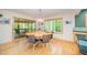 Open dining area with hardwood floors, a modern light fixture, and access to the screened porch at 2612 Scarlet Sage Ct, Raleigh, NC 27613
