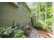 Exterior of the house with greenery, air conditioning unit and a stepped pathway to the back of the house at 2612 Scarlet Sage Ct, Raleigh, NC 27613