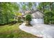 Charming home exterior featuring a well-manicured lawn, mature trees, and a convenient two-car garage at 2612 Scarlet Sage Ct, Raleigh, NC 27613