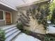 Inviting front entrance with stone steps, a wooden door, and a landscaped garden at 2612 Scarlet Sage Ct, Raleigh, NC 27613