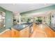 Open kitchen with hardwood floors, granite counters, and a view to the living spaces at 2612 Scarlet Sage Ct, Raleigh, NC 27613
