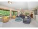 Basement living room with a grey wrap around sofa, a fireplace, and sliding doors to the exterior at 2612 Scarlet Sage Ct, Raleigh, NC 27613