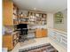 Comfortable home office with built-in wooden bookshelves and a desk with a monitor, ideal for working from home at 2612 Scarlet Sage Ct, Raleigh, NC 27613
