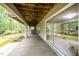 Covered patio with concrete floors and views of the lush green yard and the house interior through sliding glass doors at 2612 Scarlet Sage Ct, Raleigh, NC 27613