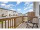 Relaxing balcony with wooden railing and a comfortable chair, offering a serene outdoor space at 2708 Chert Ln, Raleigh, NC 27610