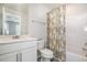 White bathroom featuring a bathtub and shower with a floral shower curtain at 2708 Chert Ln, Raleigh, NC 27610