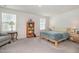 Bright bedroom featuring carpeted floors, a large bed, a bookshelf and plenty of natural light at 2708 Chert Ln, Raleigh, NC 27610