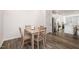 Cozy dining area featuring a wooden table and chairs, adjacent to the kitchen and living spaces at 2708 Chert Ln, Raleigh, NC 27610