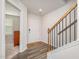 Inviting entryway with hardwood floors, staircase, and view into the light-filled living space at 2708 Chert Ln, Raleigh, NC 27610
