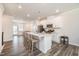 Spacious kitchen with white cabinets, stainless steel appliances, and an island with barstool seating at 2708 Chert Ln, Raleigh, NC 27610