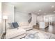 Open-concept living room with hardwood floors, a comfortable sectional, and seamless flow to the kitchen at 2708 Chert Ln, Raleigh, NC 27610