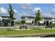 View of new townhomes and community outdoor lounge area, with lawn and benches at 2708 Chert Ln, Raleigh, NC 27610