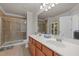 Bathroom with double sinks, a large mirror, a walk-in shower, and ample counter space at 276 Linden Park Ln, Cary, NC 27519
