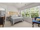 Bright bedroom with a large window, neutral walls, and a cozy bed at 276 Linden Park Ln, Cary, NC 27519
