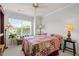 Comfortable bedroom with a large window, ceiling fan, and cozy bedding with lamps at 276 Linden Park Ln, Cary, NC 27519