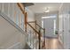 Inviting entryway with hardwood floors, stairs, and natural light creating a warm and welcoming ambiance at 276 Linden Park Ln, Cary, NC 27519