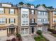 Attractive townhome exterior features a brick facade, attached garage, and neatly landscaped front yard at 276 Linden Park Ln, Cary, NC 27519