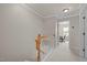 Bright hallway with neutral walls, white trim, and access to another room or area in the house at 276 Linden Park Ln, Cary, NC 27519