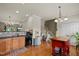 The kitchen features wood cabinetry, an island with a red base, and an adjacent staircase at 276 Linden Park Ln, Cary, NC 27519