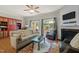 Cozy living room with a fireplace, decorative rug, comfortable seating, and sliding doors to the outdoor patio at 276 Linden Park Ln, Cary, NC 27519