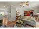 Open-concept living room showcasing hardwood floors, a decorative rug, comfortable sofa, and colorful cabinet at 276 Linden Park Ln, Cary, NC 27519