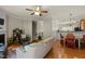 Spacious open-concept living room with hardwood floors, comfortable seating, and direct access to the dining area at 276 Linden Park Ln, Cary, NC 27519