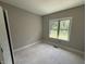 Light-filled bedroom with a large window providing a view of the natural outdoor landscape and rough-in electric at 2760 Rains Mill Rd, Princeton, NC 27569