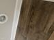 Close up of the warm, wood-look flooring and white baseboards in the house at 2760 Rains Mill Rd, Princeton, NC 27569