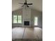 Bright living room featuring a fireplace, large window, and access to an outdoor deck at 2760 Rains Mill Rd, Princeton, NC 27569
