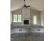 Bright living room featuring a fireplace, large window, and access to an outdoor deck at 2760 Rains Mill Rd, Princeton, NC 27569